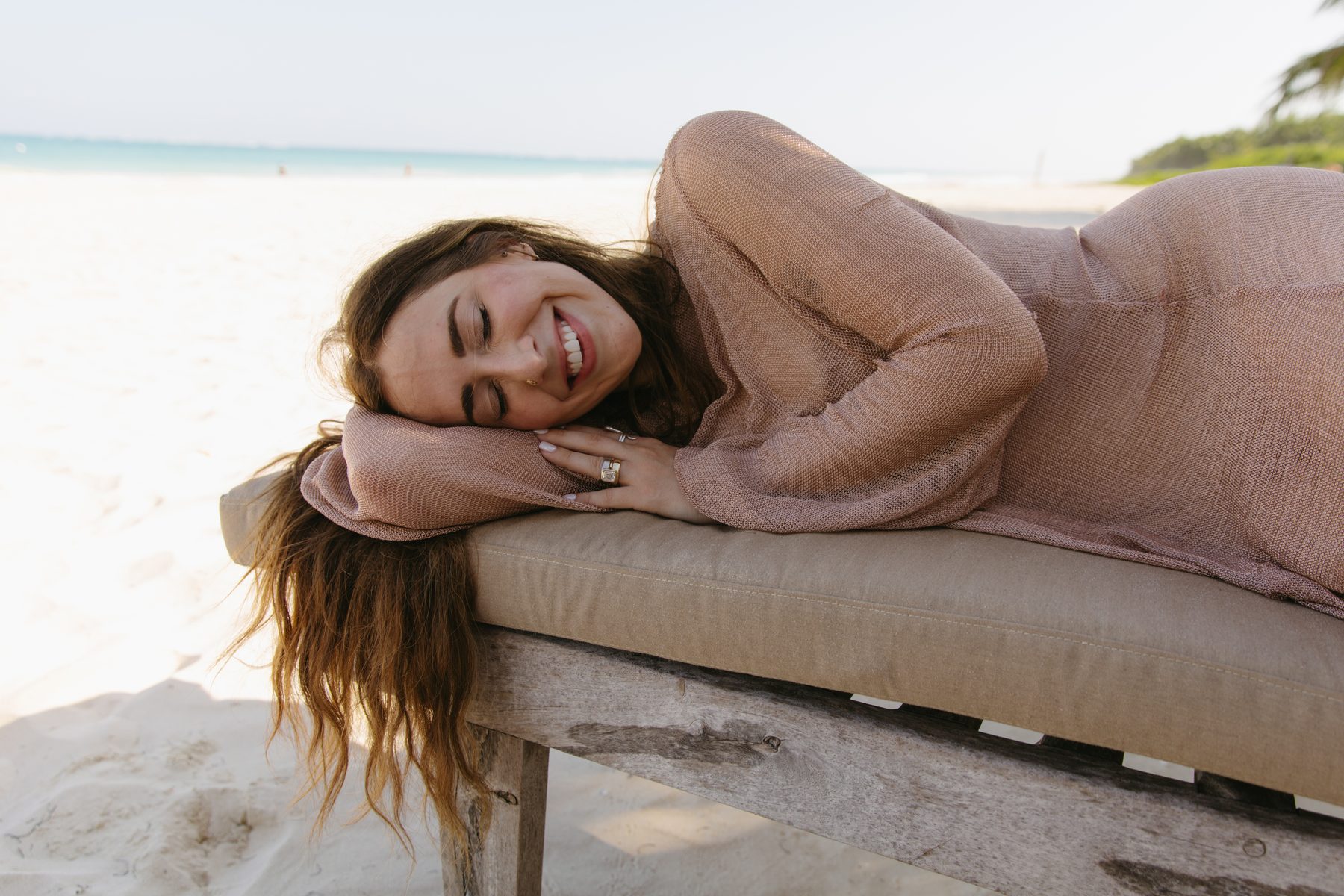 A beauty professional resting peacefully on a beach lounger