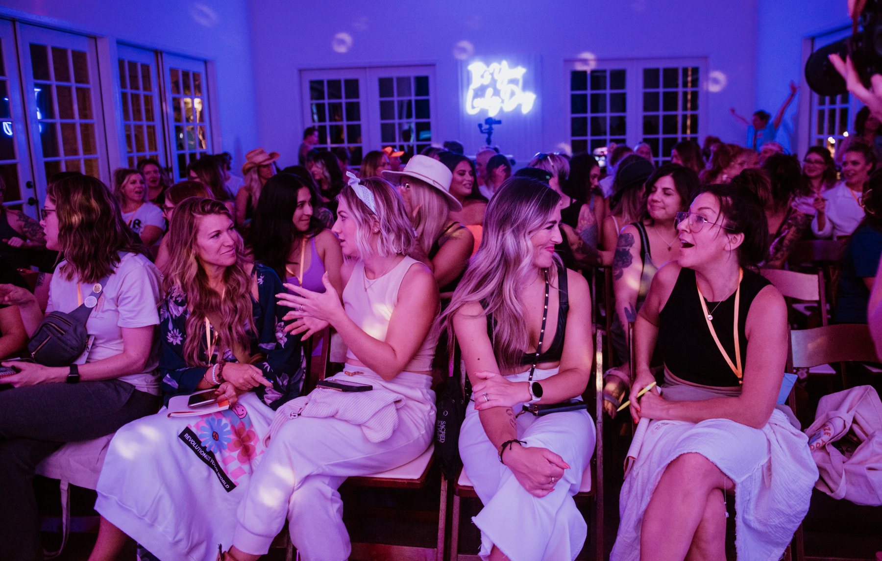 Beauty pros laughing together in the crowd at a Vitality Project event