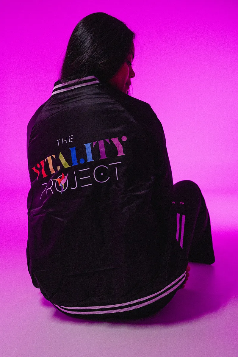 A beauty professional wearing The Vitality Project bomber jacket