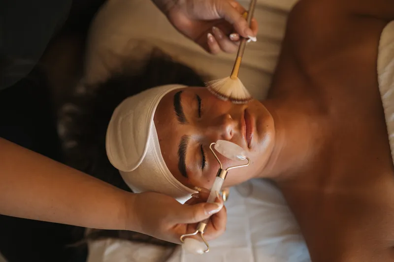 A student practising a facial treatment on a client