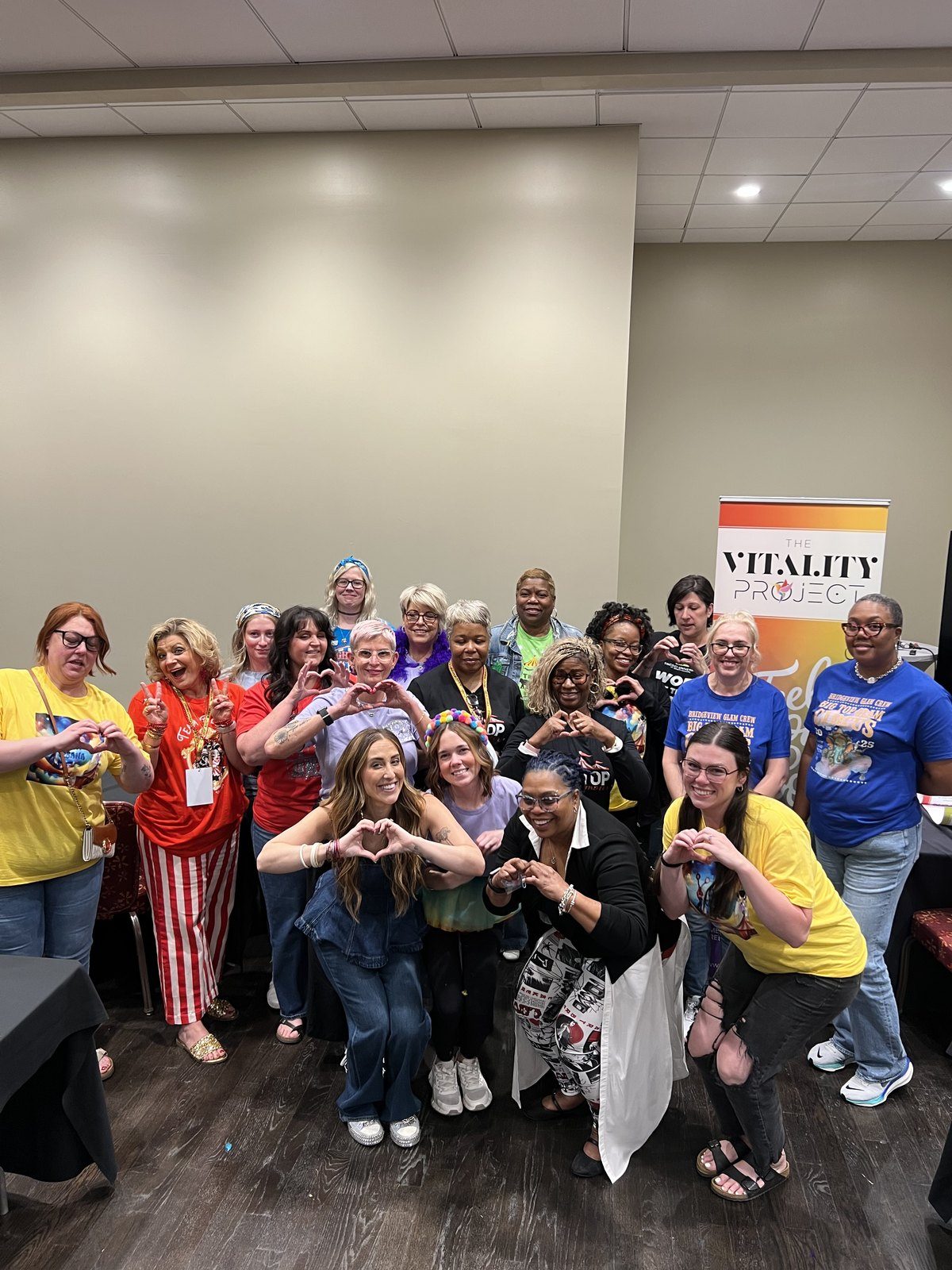 A whole school cohort making heart hands together