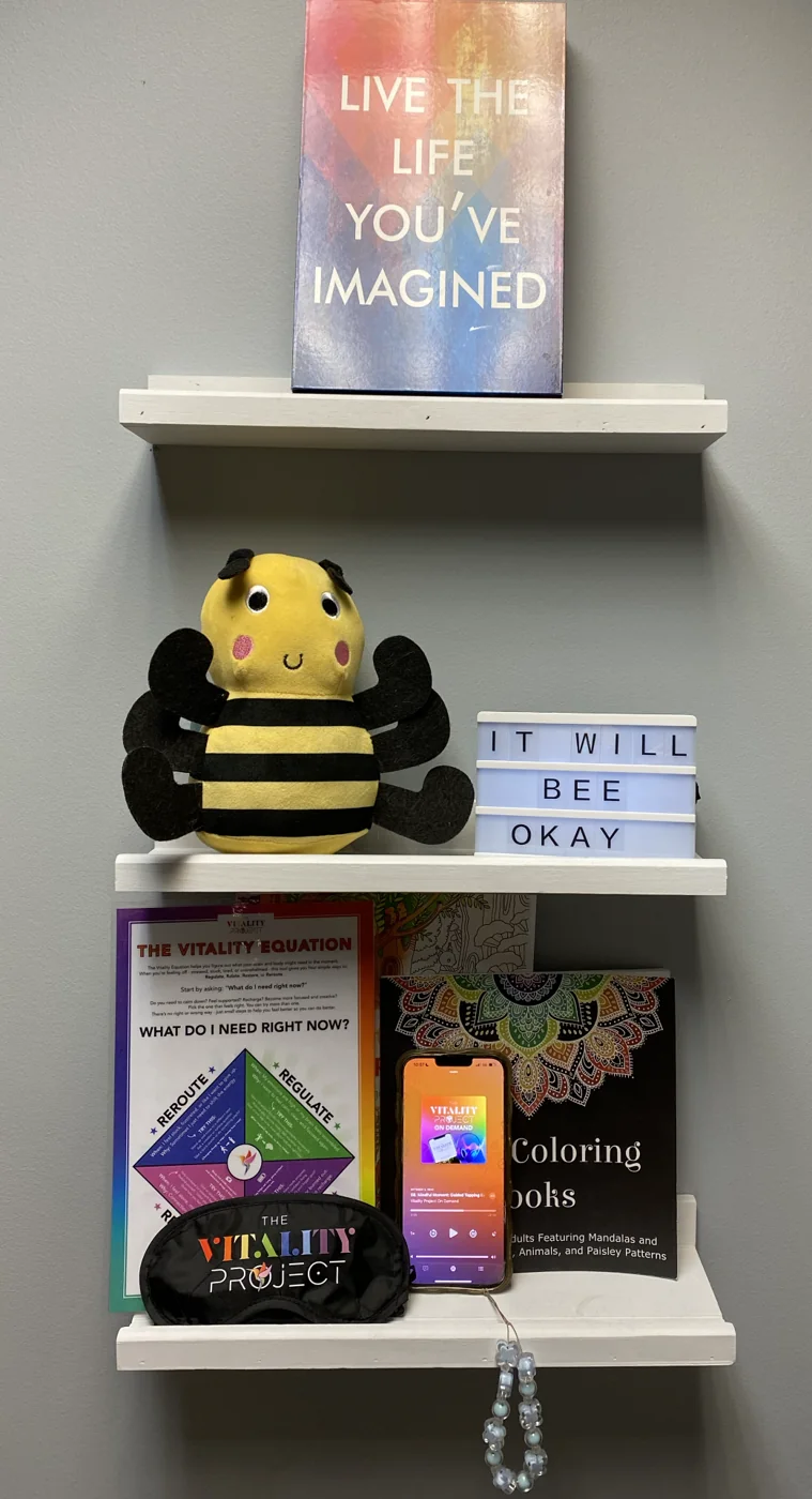 The Vitality Pod shelf: the bee, the It Will Bee Okay sign, the Vitality Equation, the eye mask and the app