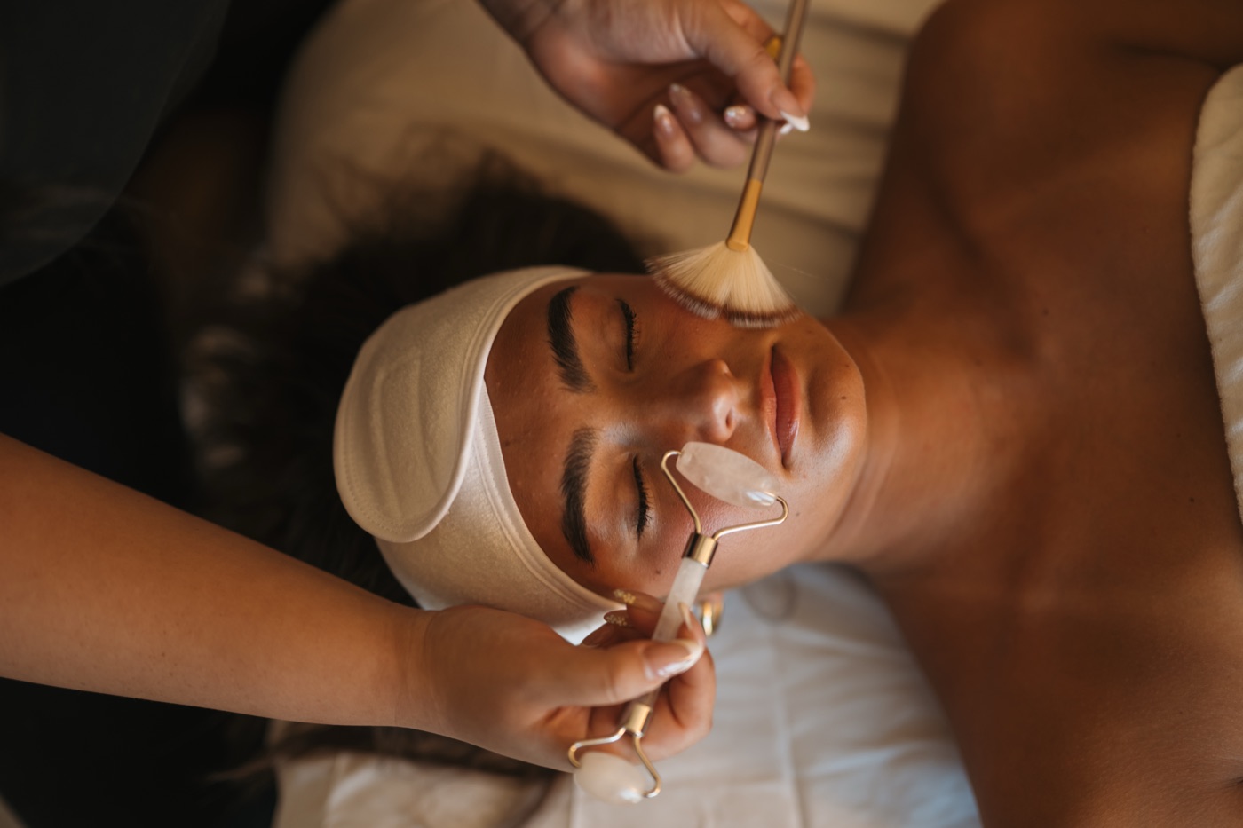 An esthetician performing a facial treatment