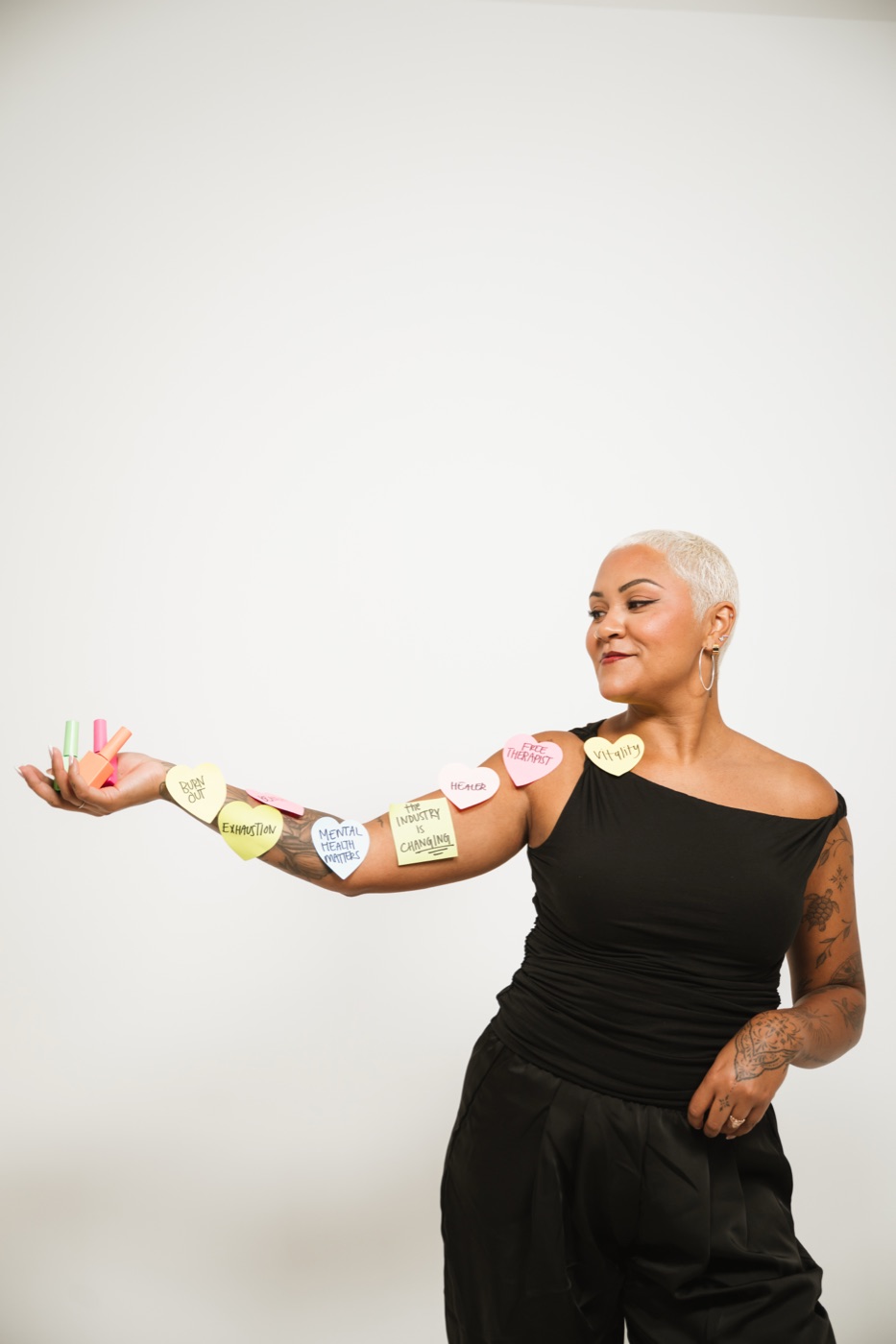 A nail tech holding polish