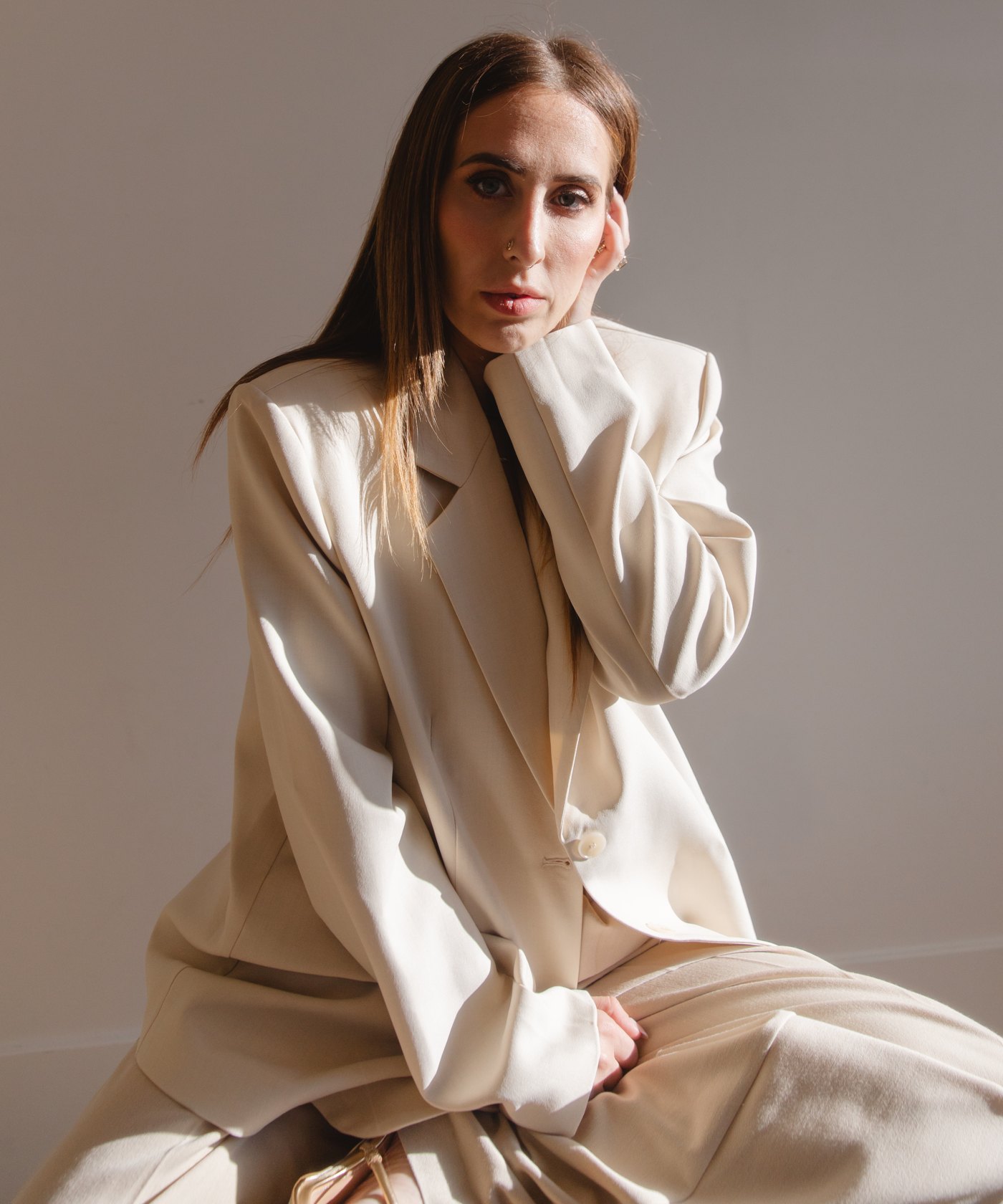 Elizabeth Faye in a cream suit