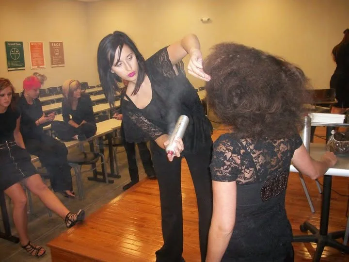 Elizabeth Faye teaching a class, working on a model in front of seated students