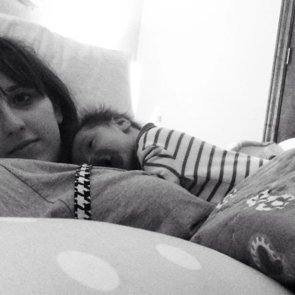 Elizabeth Faye at home with her baby, in black and white