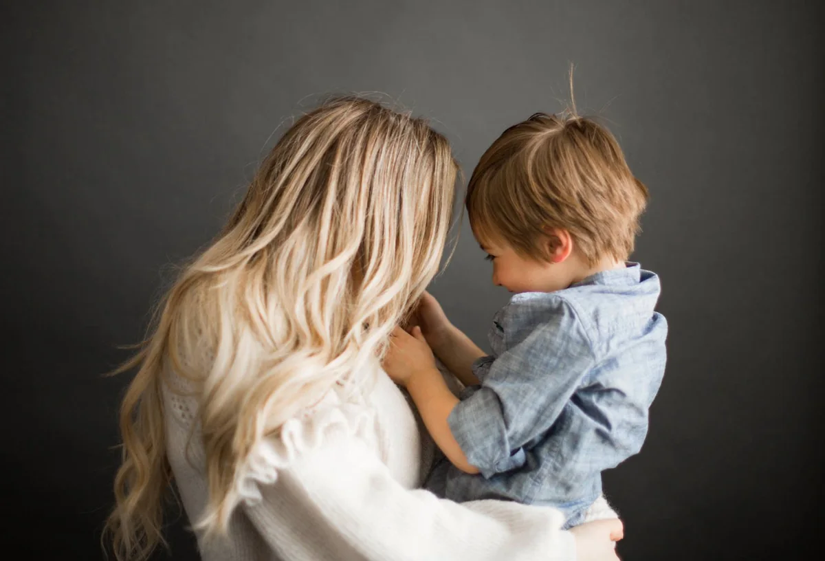 Elizabeth Faye holding her son