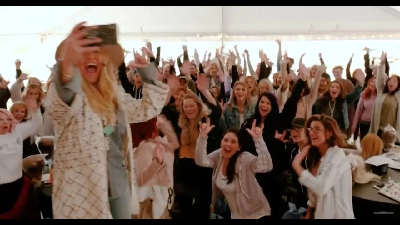 The Hair Love Retreat, a room of beauty pros with their hands in the air