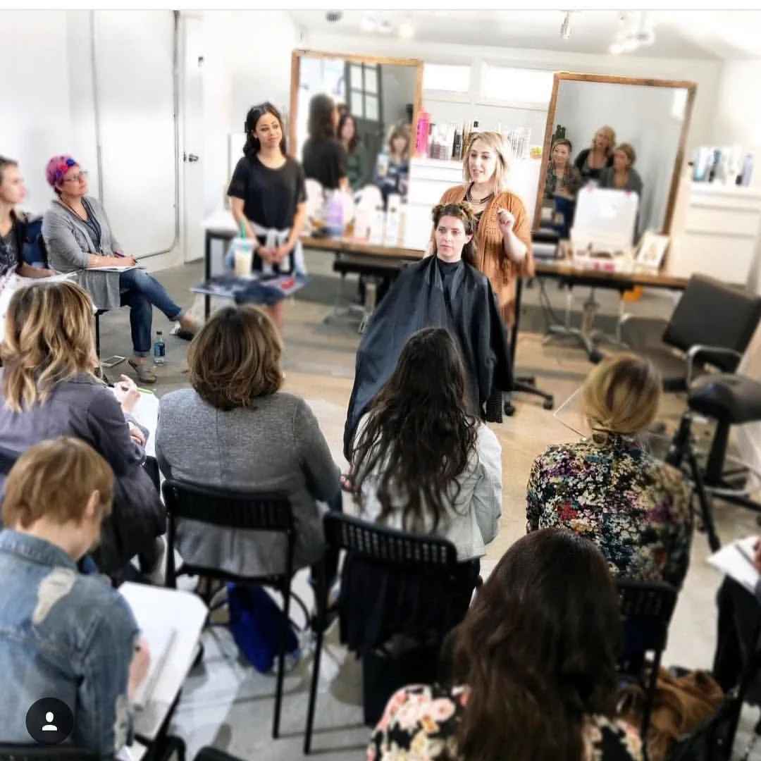 Elizabeth Faye teaching a room of stylists as the Hair Love community starts