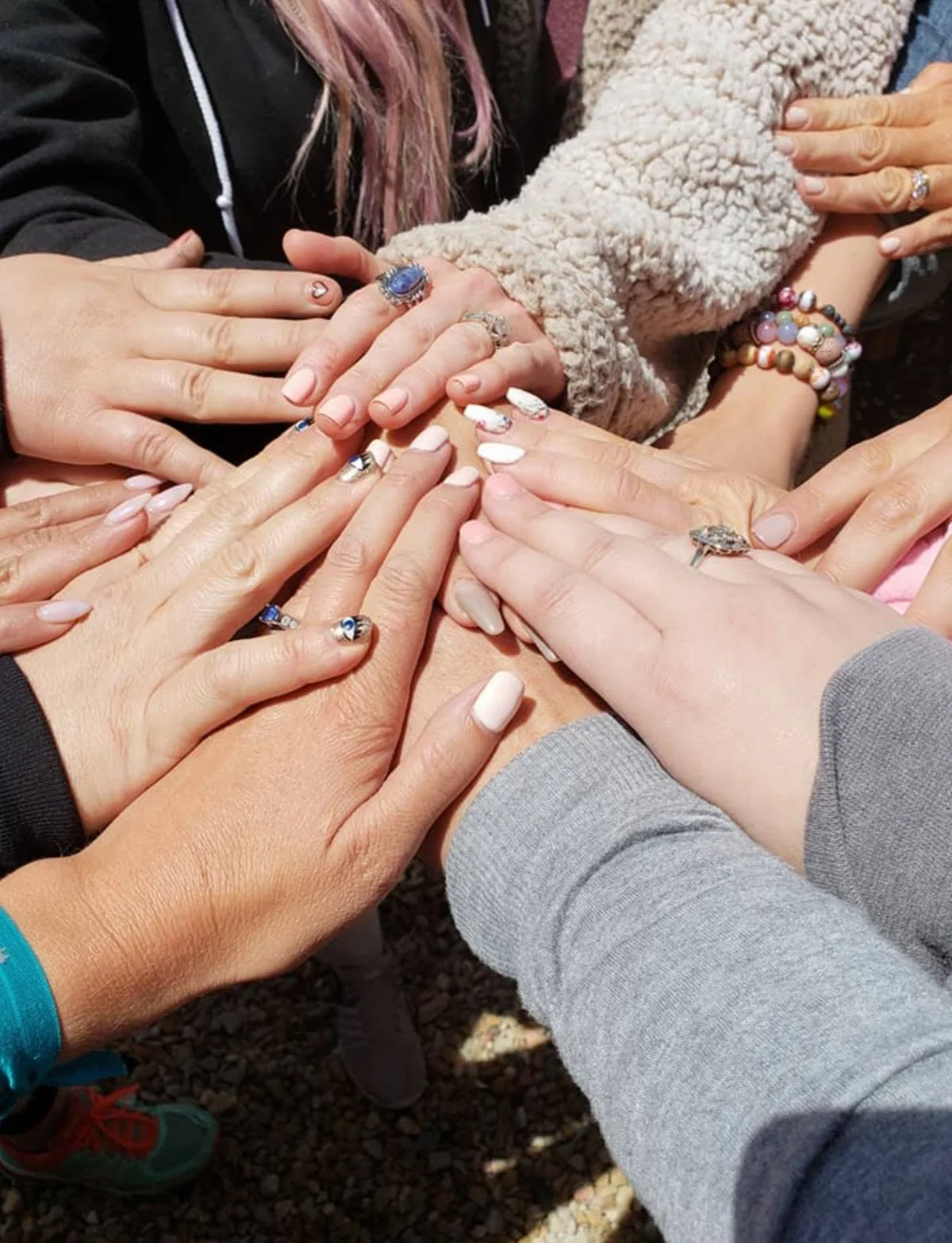 Hands together in a circle on the road during the tour